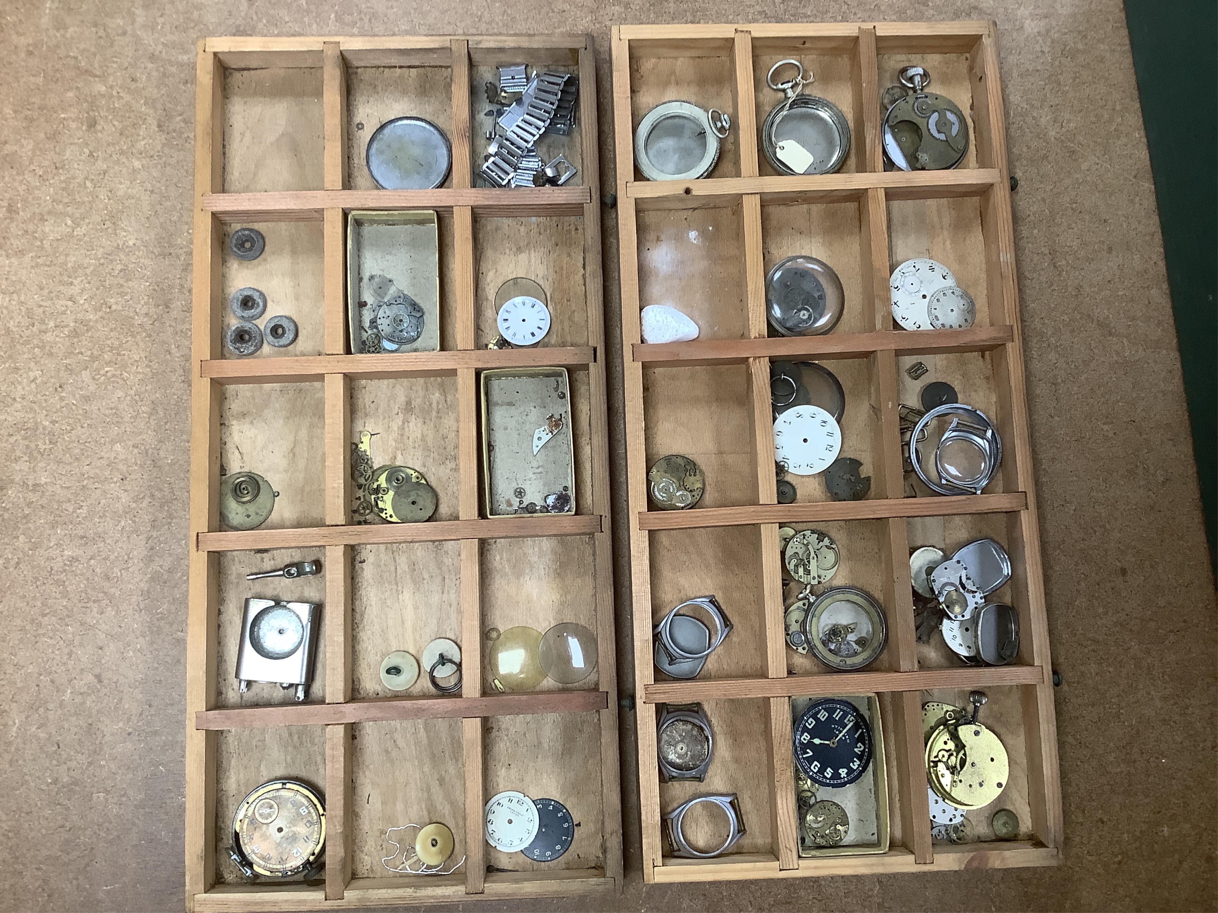 A wooden twelve drawer cabinet containing a collection of watch parts. Condition - cabinet fair to good, watch parts as found